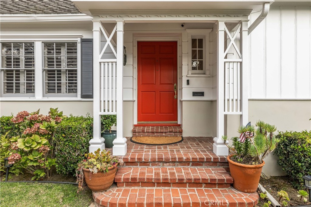 The red front door with brick steps