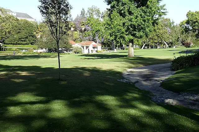 Holmby Park's broad lawn beneath mature trees