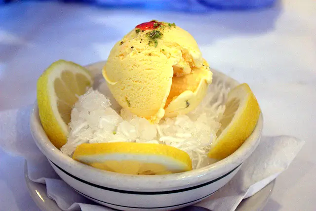 A scoop of saffron ice cream over faloodeh noodles with lemon